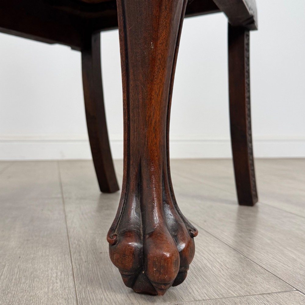 A dark carved rosewood dining suite featuring a rectangular table with carved cabriole legs accompanied by six splat-back chairs including two armchairs. View XV
