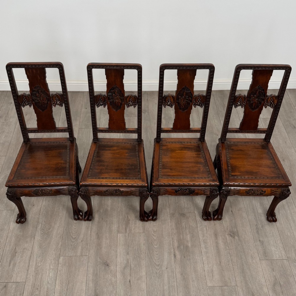 A dark carved rosewood dining suite featuring a rectangular table with carved cabriole legs accompanied by six splat-back chairs including two armchairs. View XVI