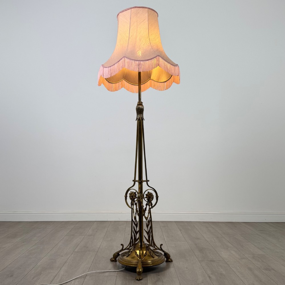 An antique 19th-century brass floor standing lamp featuring an ornate cast base with claw feet and a pink fringed shade. View III