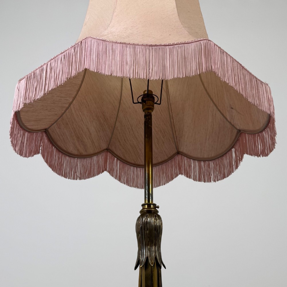 An antique 19th-century brass floor standing lamp featuring an ornate cast base with claw feet and a pink fringed shade. View IV