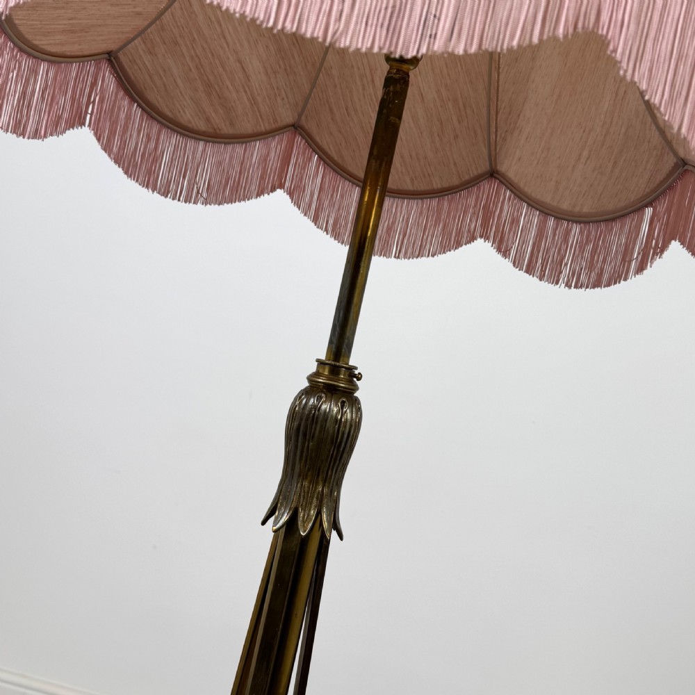 An antique 19th-century brass floor standing lamp featuring an ornate cast base with claw feet and a pink fringed shade. View V
