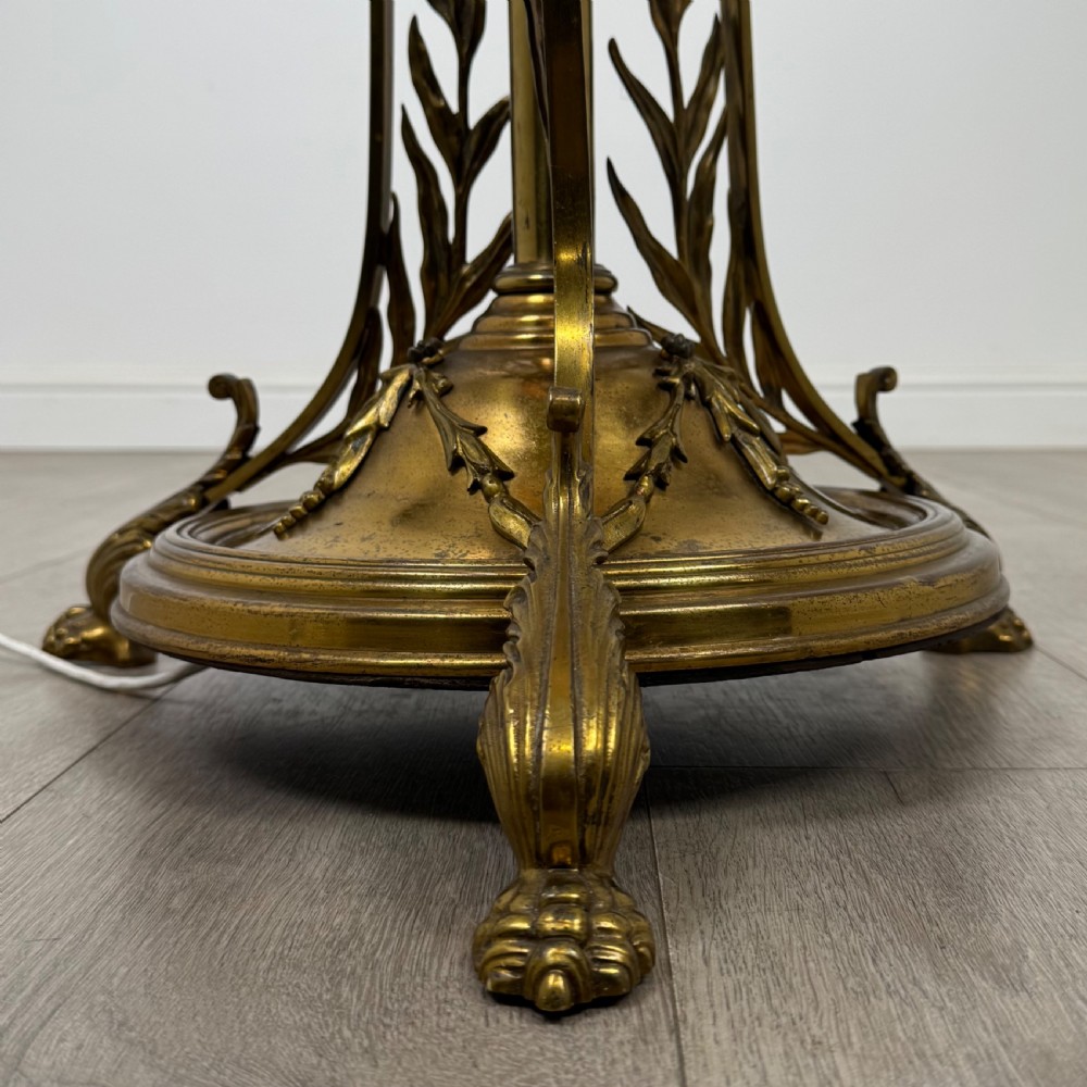 An antique 19th-century brass floor standing lamp featuring an ornate cast base with claw feet and a pink fringed shade. View VII
