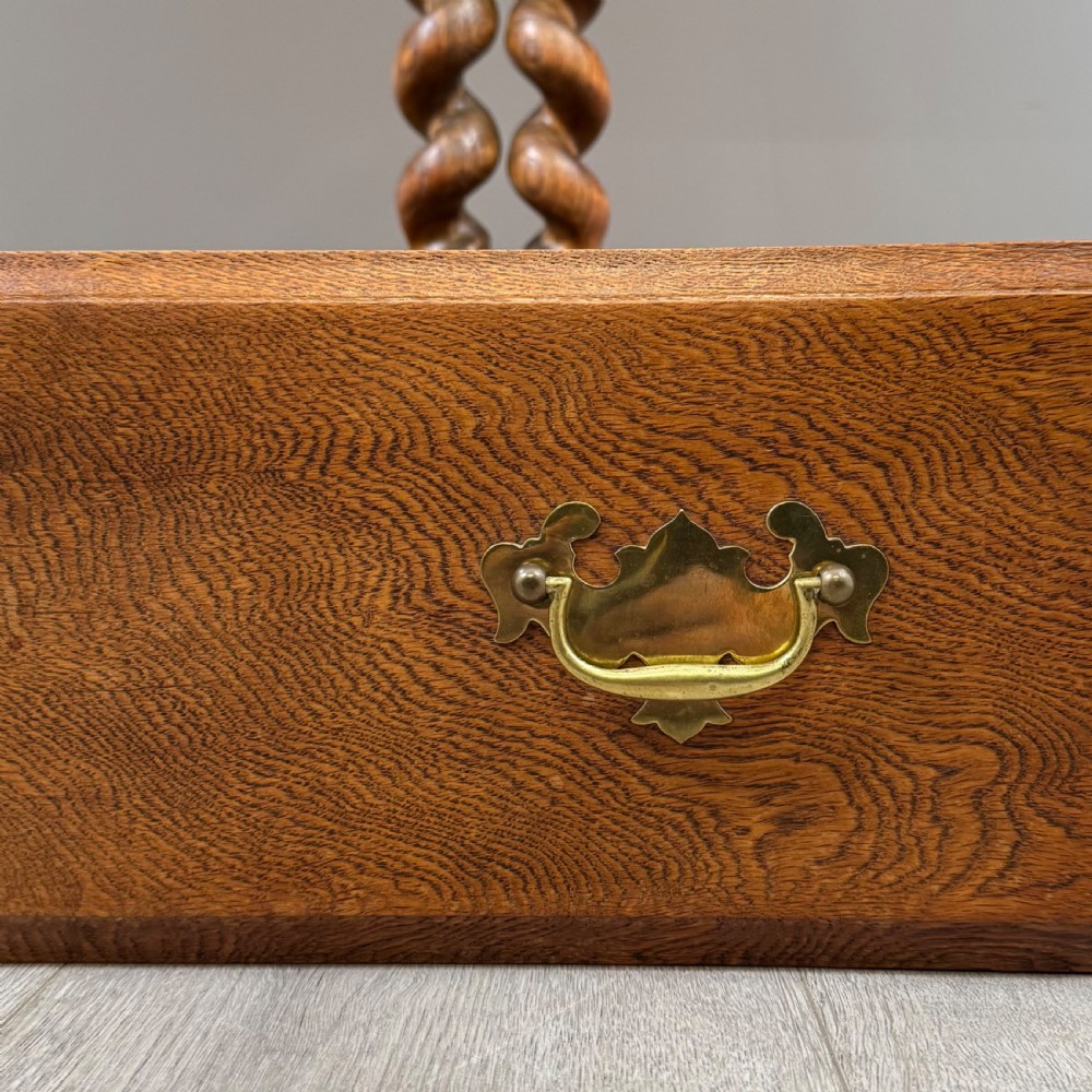 A golden oak kitchen dresser featuring an upper shelving rack with side cupboards and a lower base with two drawers, barley twist legs, and an open pot board. View XII