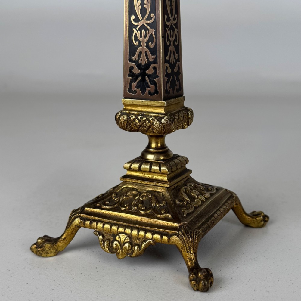 A pair of 19th-century French brass candelabra featuring ornate scrollwork arms and dark enamel inlaid details. View VI