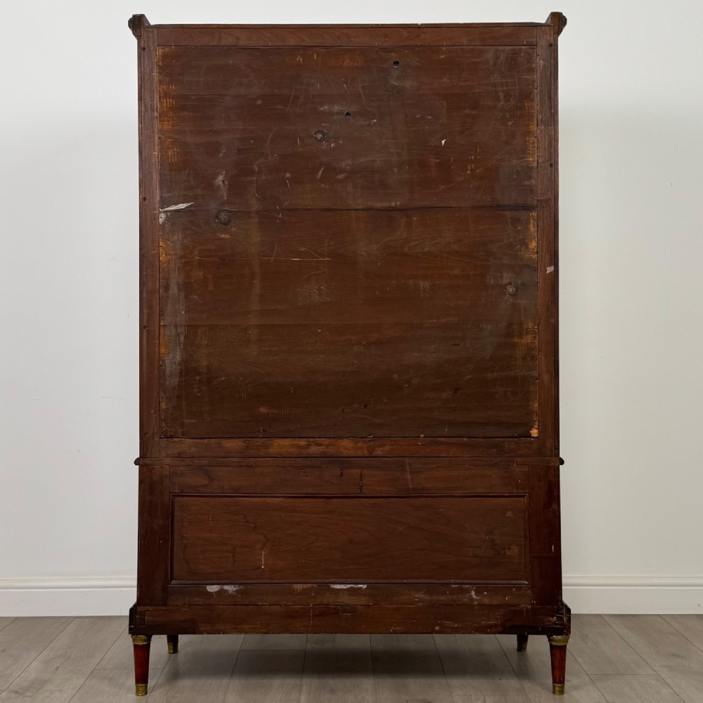 A nineteenth-century French mahogany glazed display cabinet featuring gilt-bronze mounts, glass shelving, and an open lower tier. View VI