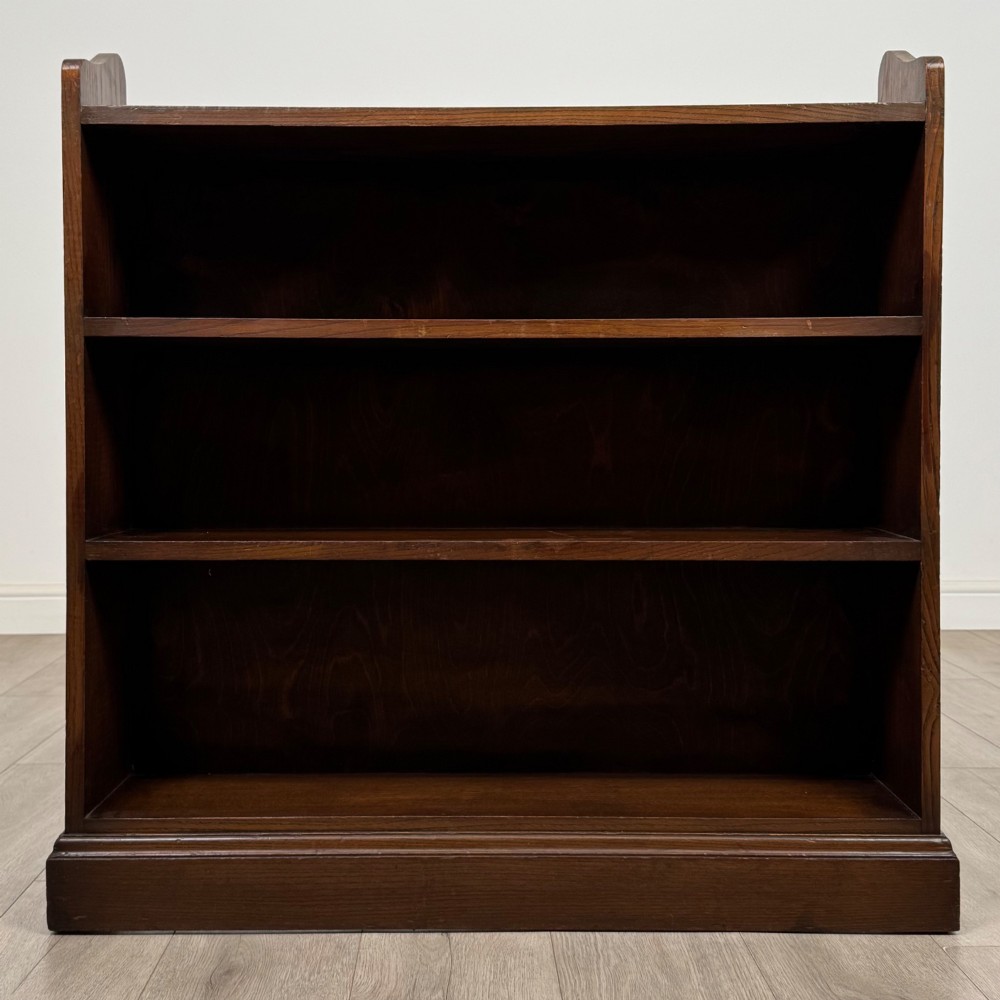 A twentieth-century dark oak open bookcase with three fitted shelves and profiled side edges. View II