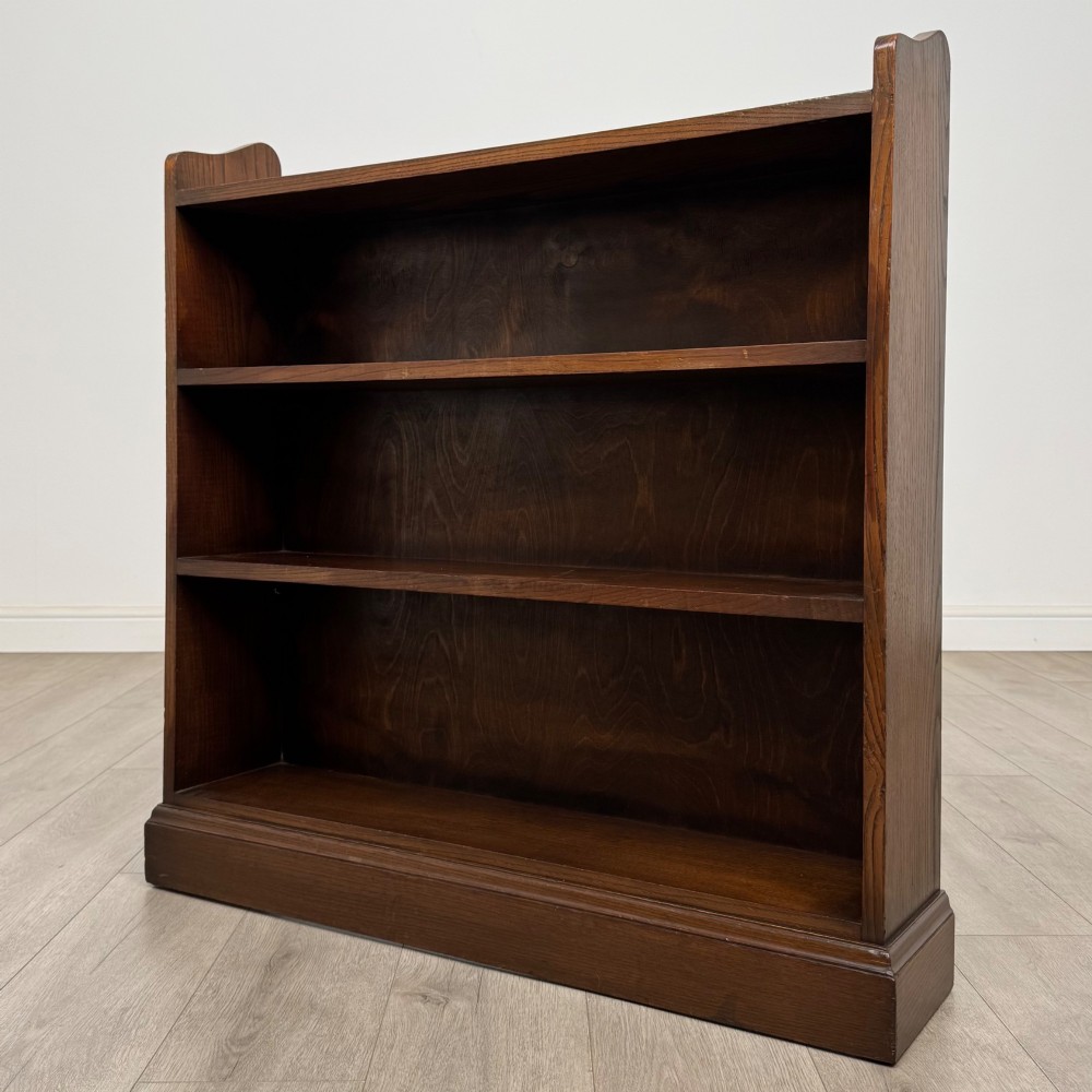 A twentieth-century dark oak open bookcase with three fitted shelves and profiled side edges. View III
