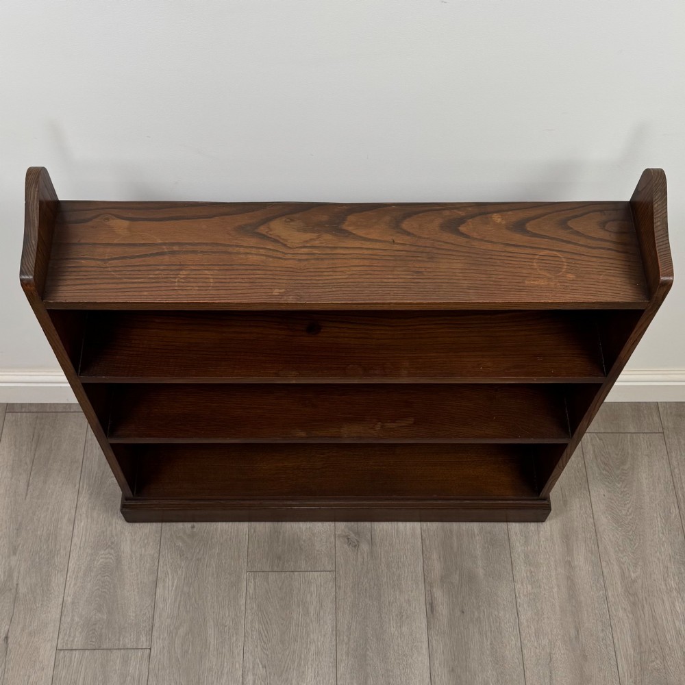 A twentieth-century dark oak open bookcase with three fitted shelves and profiled side edges. View X