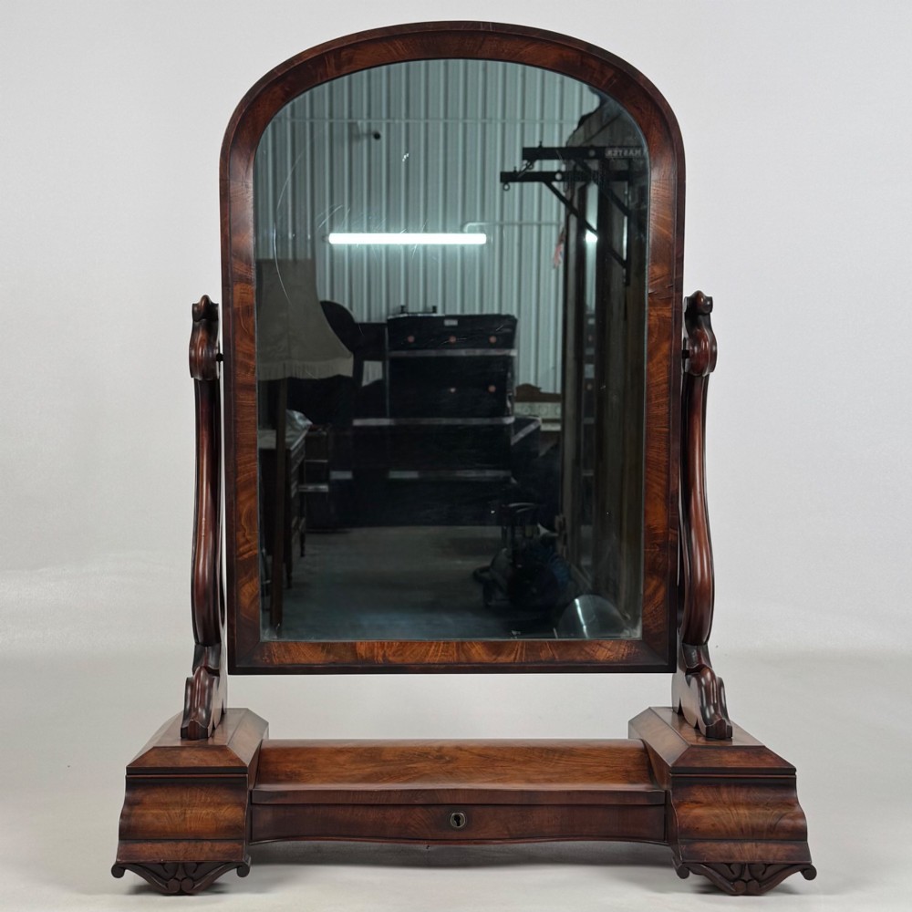 An antique Victorian dark mahogany tabletop dressing mirror featuring an arched frame supported by carved scroll uprights on a plinth base. View XII