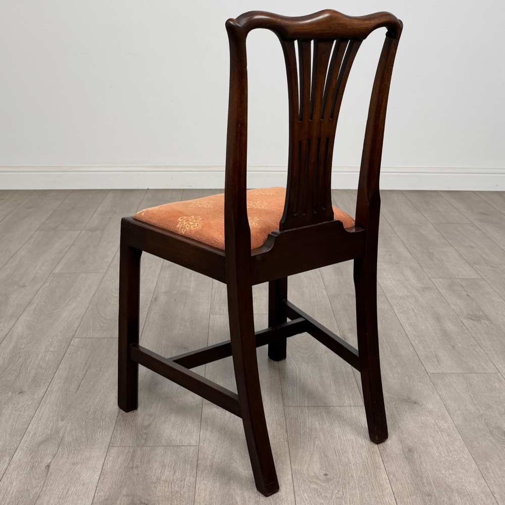 A set of eight 19th-century Georgian style mahogany dining chairs featuring carved pierced splat backs and patterned terracotta upholstery. View IV