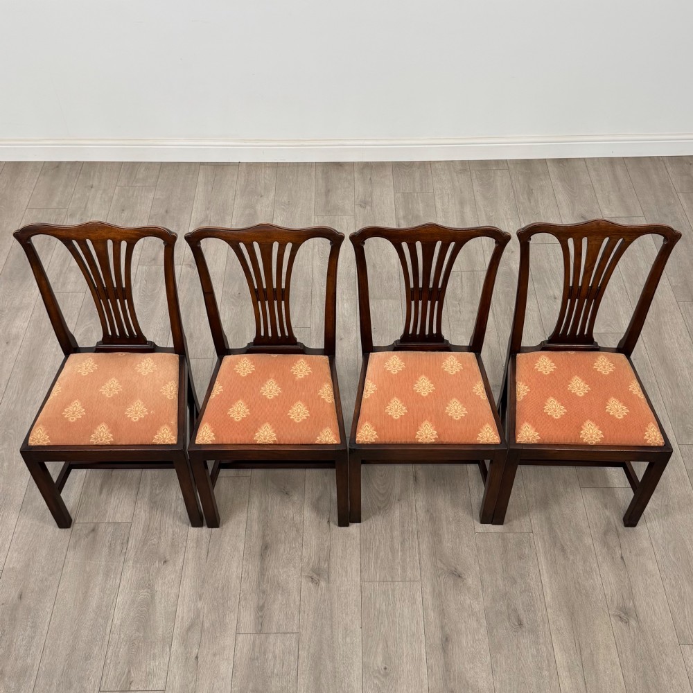 A set of eight 19th-century Georgian style mahogany dining chairs featuring carved pierced splat backs and patterned terracotta upholstery. View VIII
