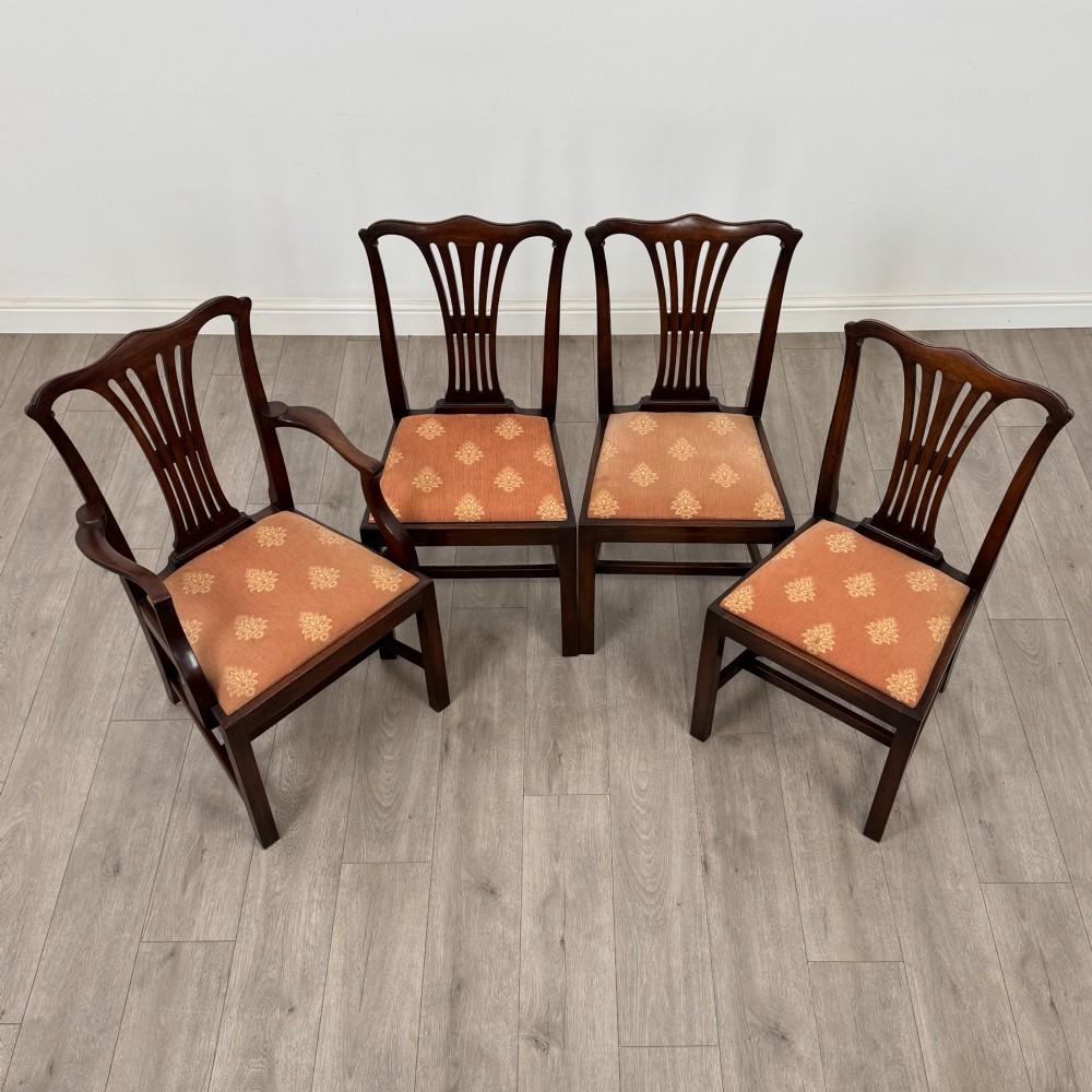A set of eight 19th-century Georgian style mahogany dining chairs featuring carved pierced splat backs and patterned terracotta upholstery. View IX