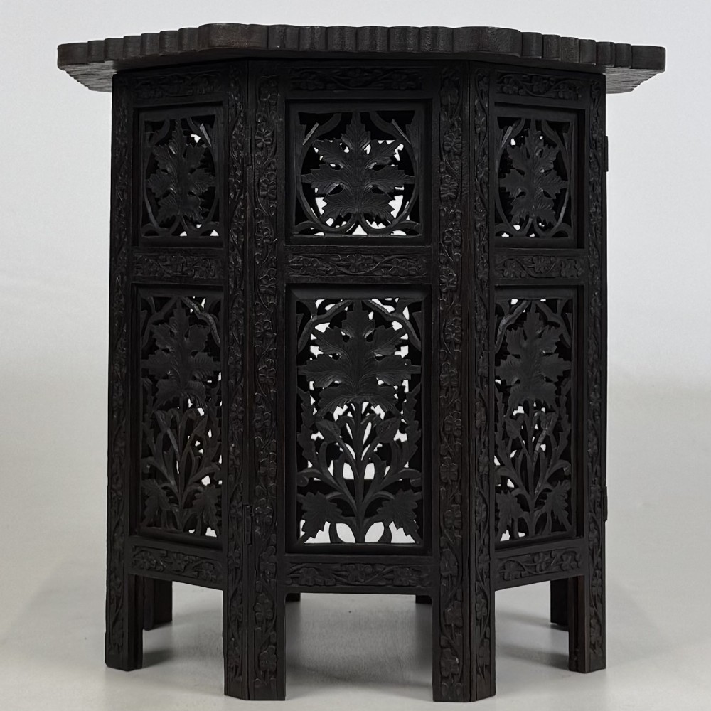 A dark brown octagonal wooden side table featuring intricate hand-carved foliate openwork panels across every side. View III