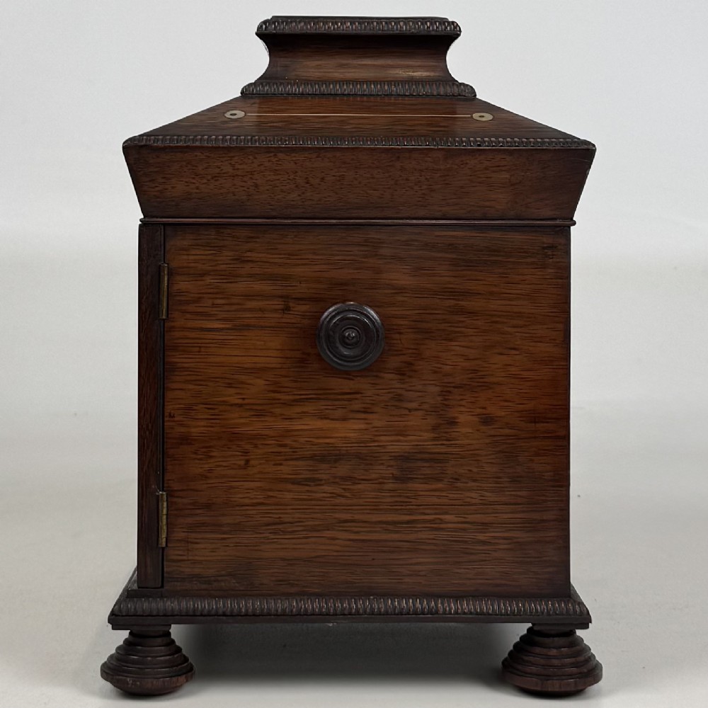 An antique dark rosewood box featuring mother-of-pearl floral inlays, twin front doors, a sarcophagus top, and turned feet. View IV