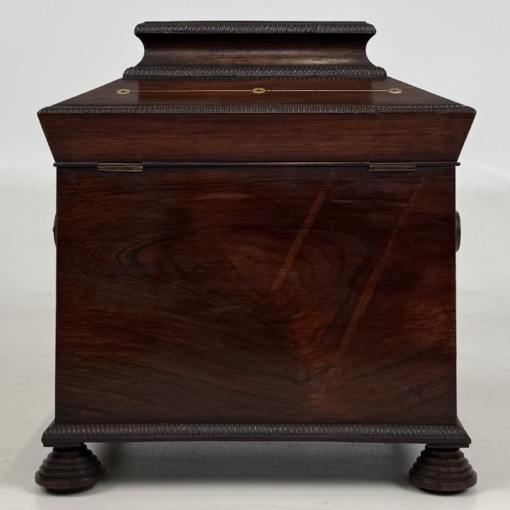 An antique dark rosewood box featuring mother-of-pearl floral inlays, twin front doors, a sarcophagus top, and turned feet. View VI