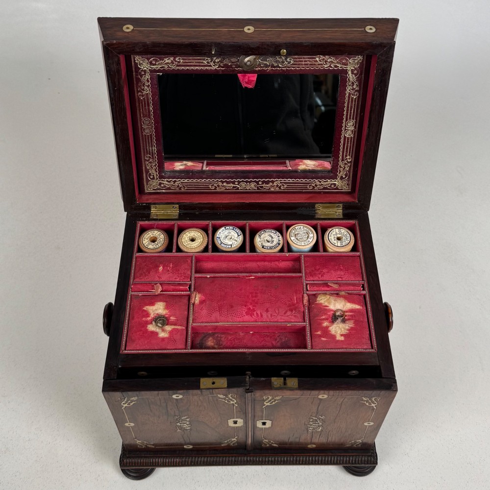An antique dark rosewood box featuring mother-of-pearl floral inlays, twin front doors, a sarcophagus top, and turned feet. View XI