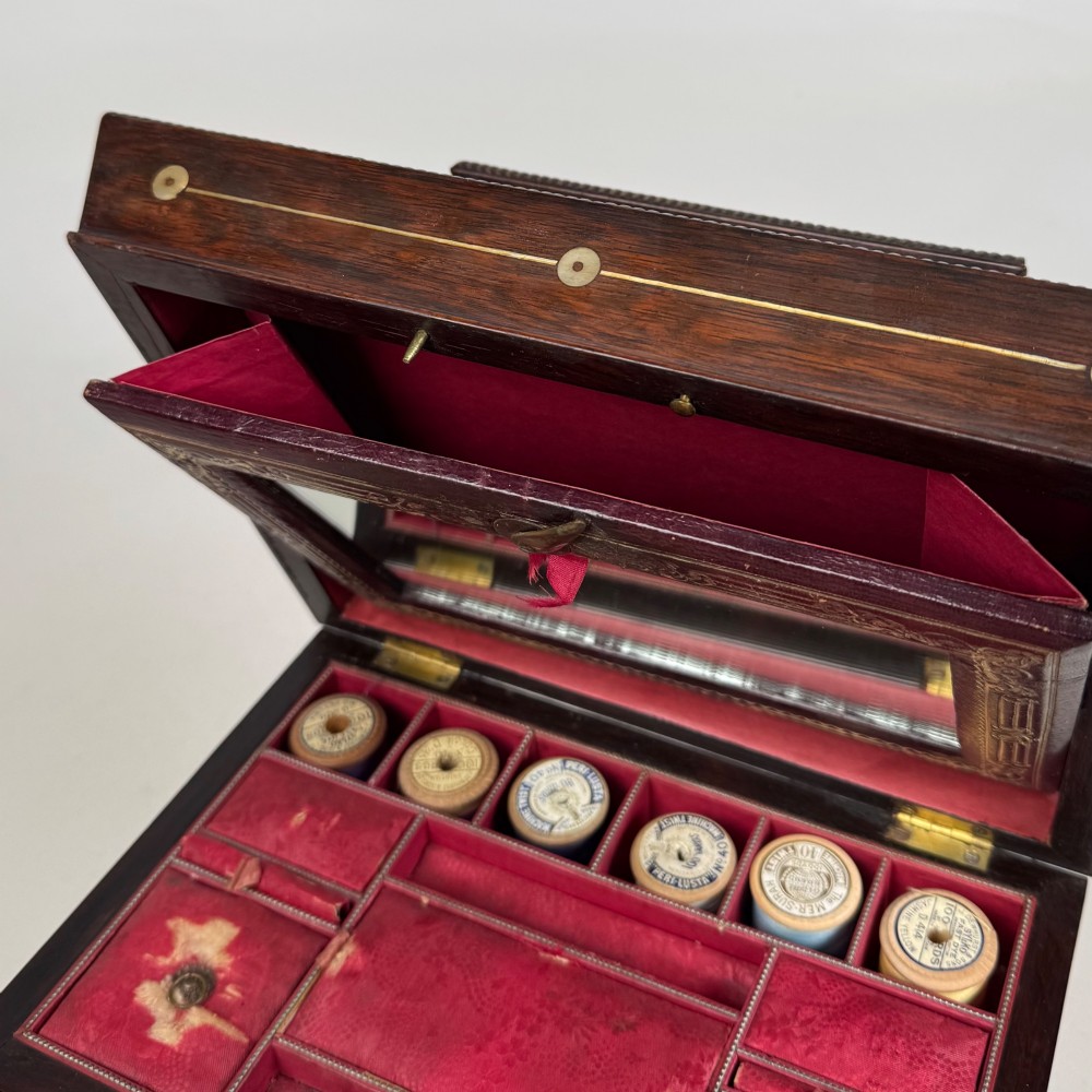 An antique dark rosewood box featuring mother-of-pearl floral inlays, twin front doors, a sarcophagus top, and turned feet. View XIV