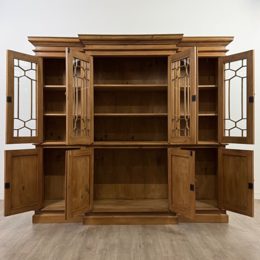 A large 20th-century pine breakfront bookcase featuring upper astragal glazed doors and lower solid panel doors. View II