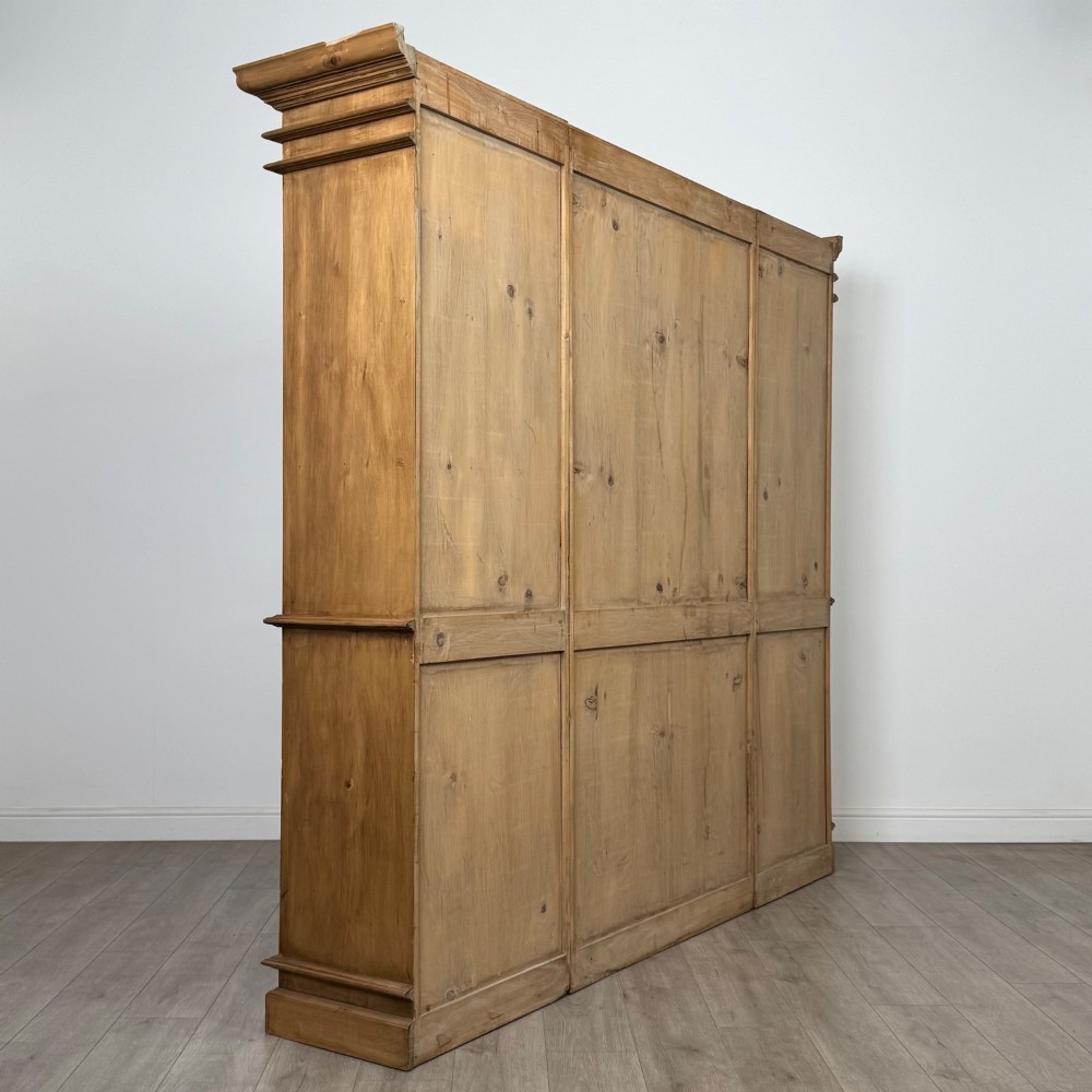 A large 20th-century pine breakfront bookcase featuring upper astragal glazed doors and lower solid panel doors. View V
