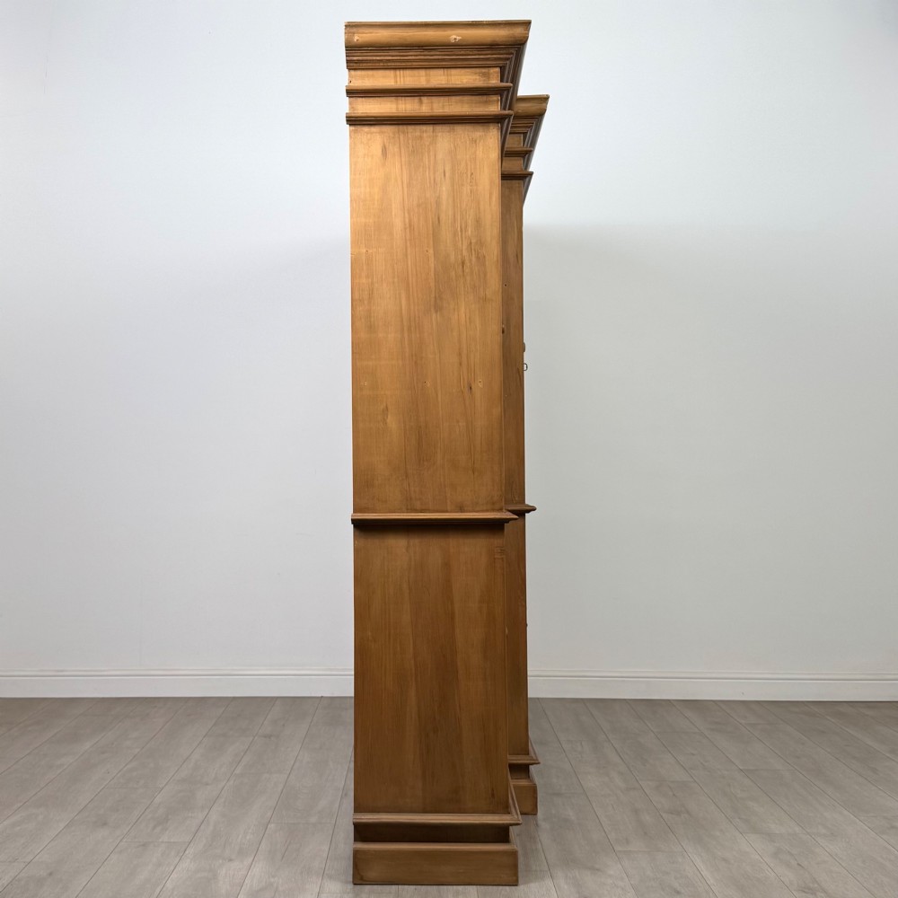 A large 20th-century pine breakfront bookcase featuring upper astragal glazed doors and lower solid panel doors. View VIII