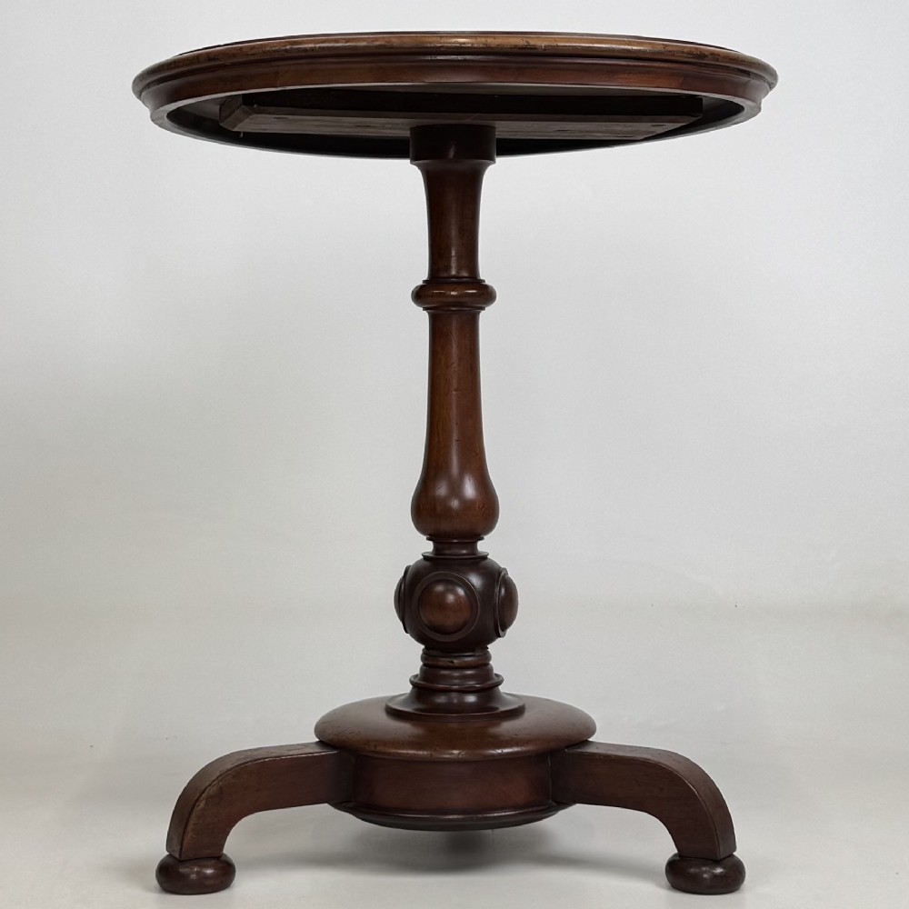 A 19th-century Victorian mahogany side table featuring a moulded circular top set upon a central turned pedestal and a four-footed base. View II