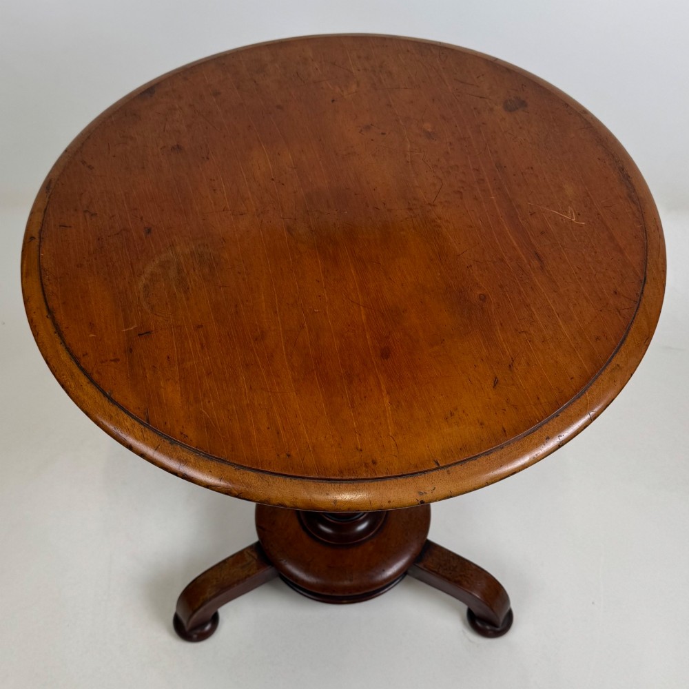 A 19th-century Victorian mahogany side table featuring a moulded circular top set upon a central turned pedestal and a four-footed base. View III