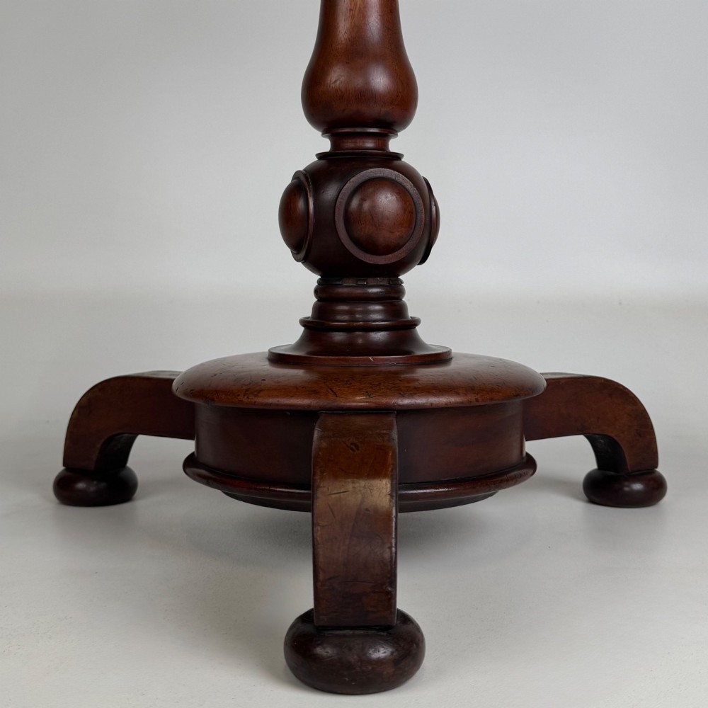 A 19th-century Victorian mahogany side table featuring a moulded circular top set upon a central turned pedestal and a four-footed base. View IV