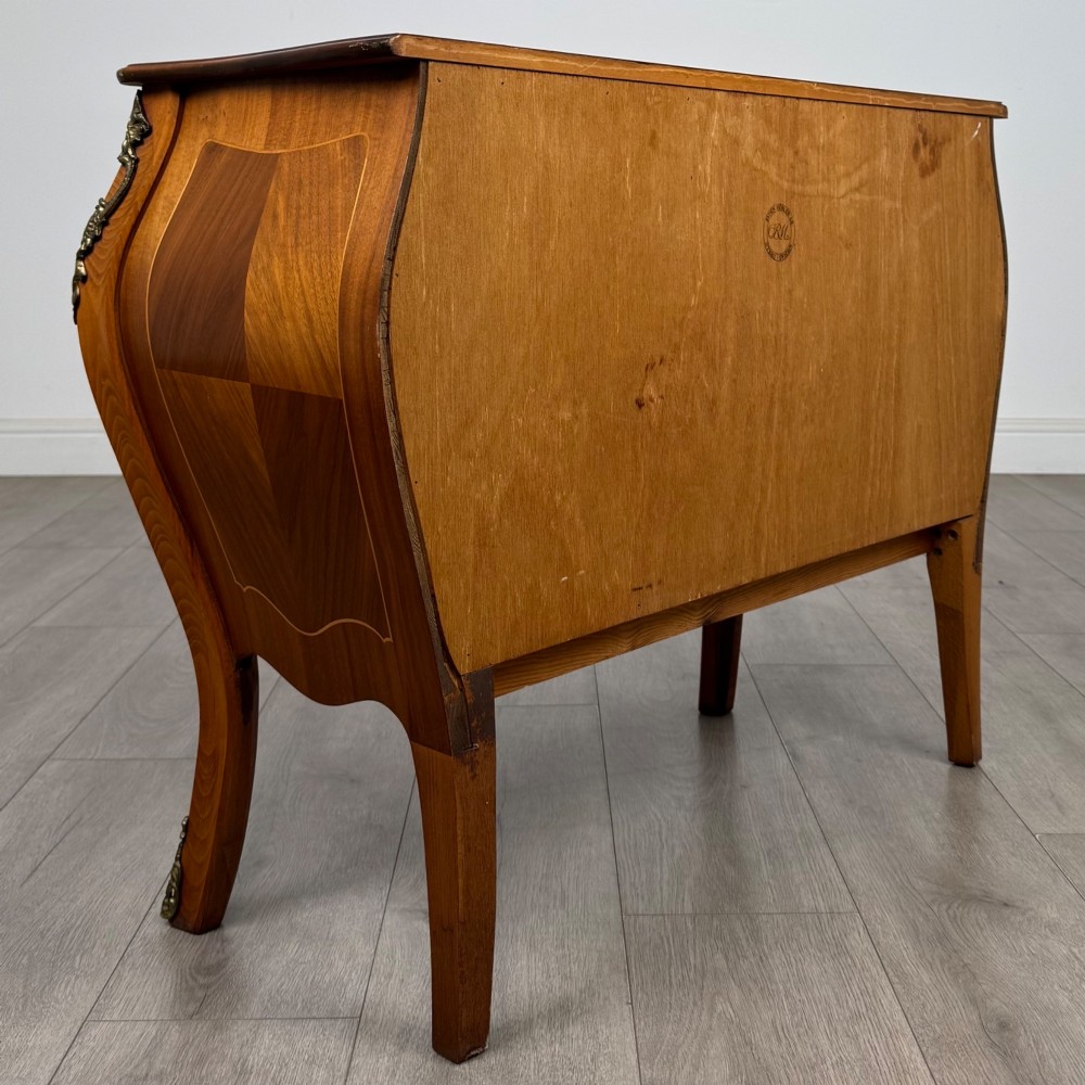 A two-drawer walnut bombe chest featuring curved sides, inlaid marquetry details, cast brass handles, and cabriole legs. View IV