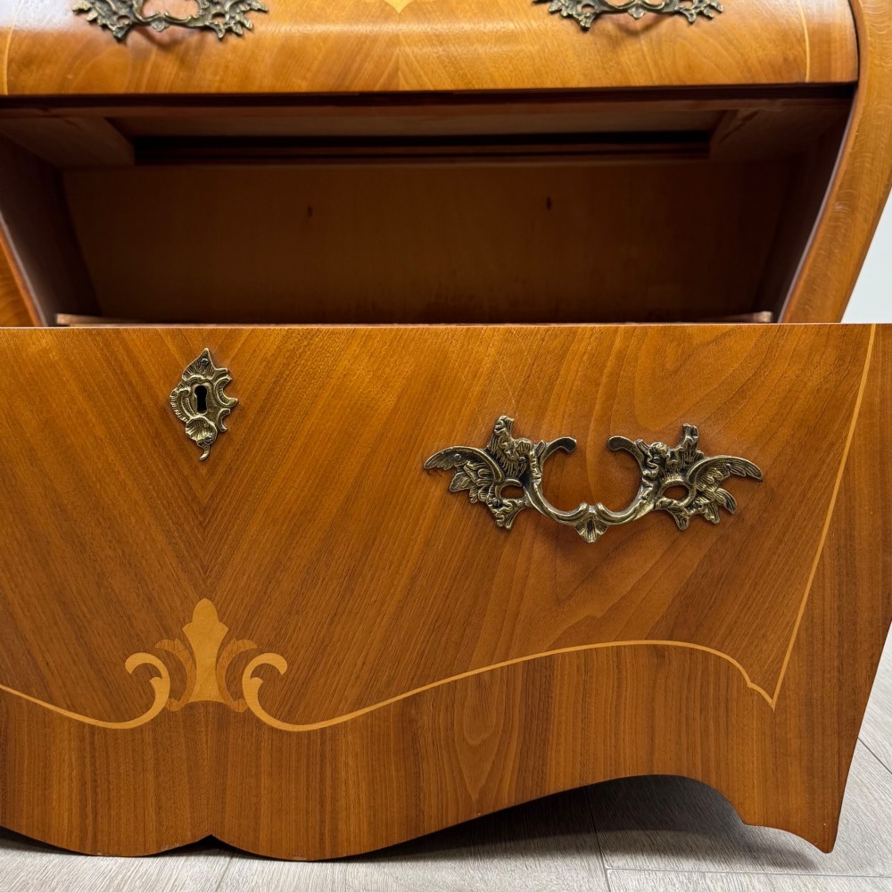 A two-drawer walnut bombe chest featuring curved sides, inlaid marquetry details, cast brass handles, and cabriole legs. View XI