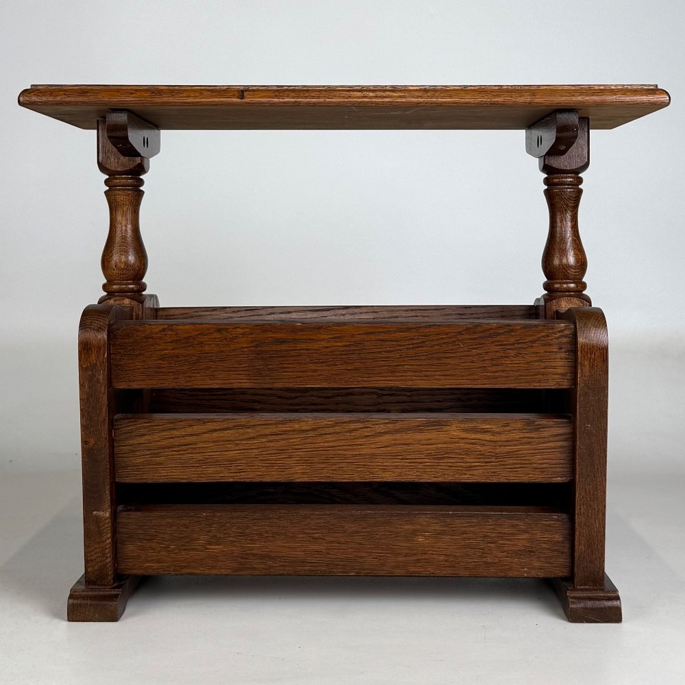 A medium oak side table featuring a flat rectangular tabletop supported by turned baluster posts above a lower slatted storage trough. View V