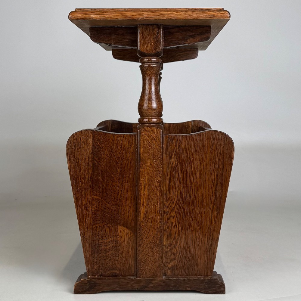 A medium oak side table featuring a flat rectangular tabletop supported by turned baluster posts above a lower slatted storage trough. View VII