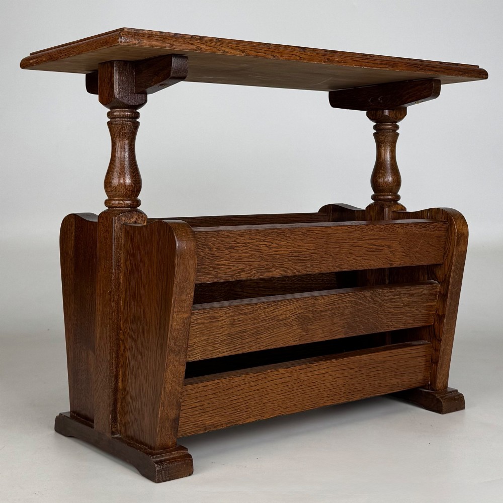 A medium oak side table featuring a flat rectangular tabletop supported by turned baluster posts above a lower slatted storage trough. View VIII