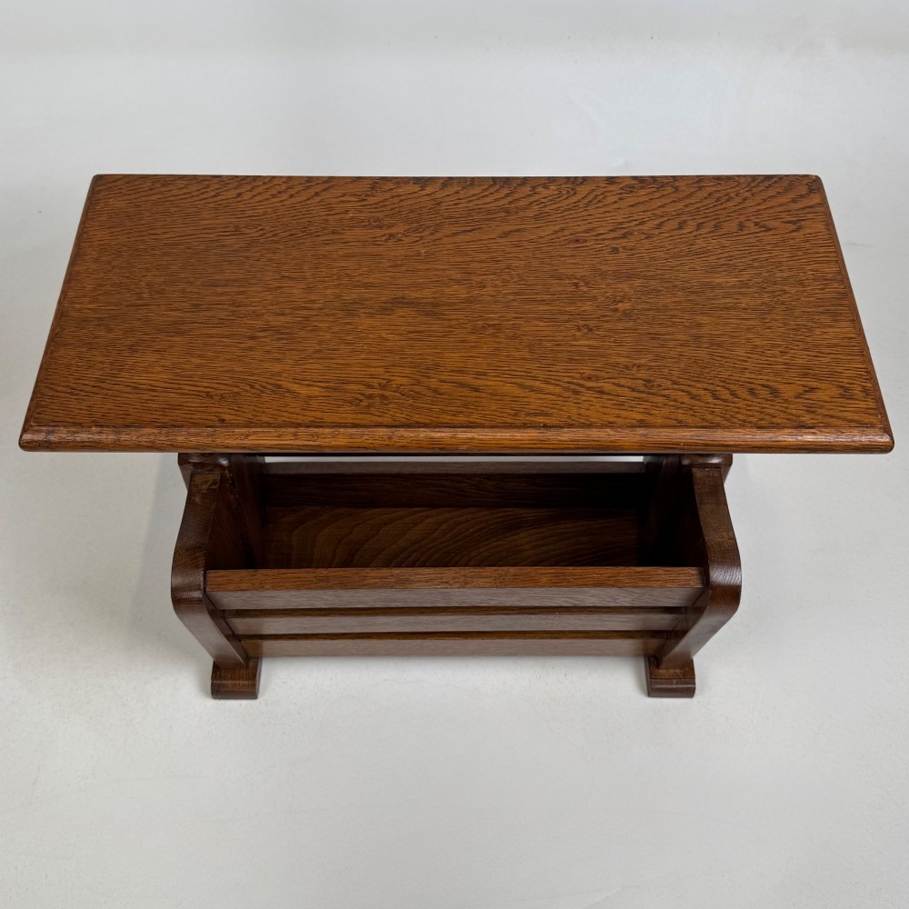 A medium oak side table featuring a flat rectangular tabletop supported by turned baluster posts above a lower slatted storage trough. View IX