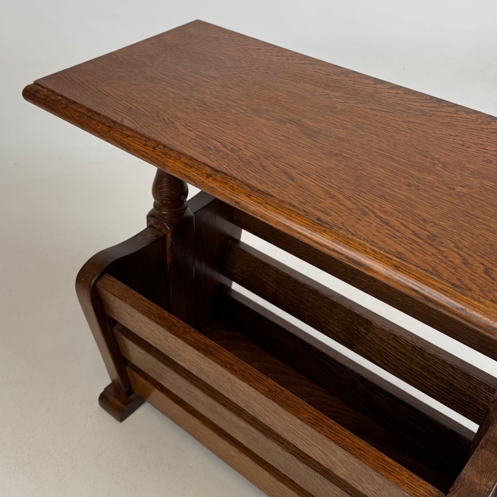 A medium oak side table featuring a flat rectangular tabletop supported by turned baluster posts above a lower slatted storage trough. View X