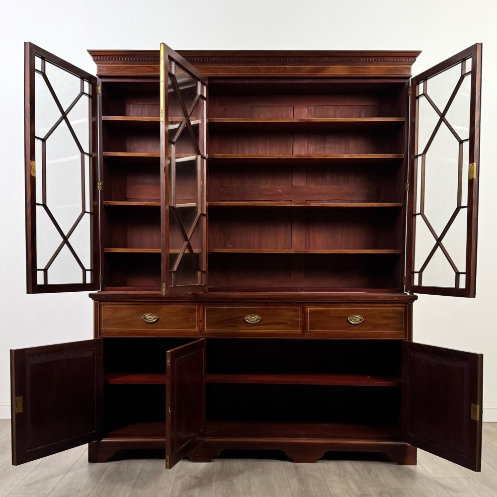 An 18th-century Georgian mahogany bookcase featuring three glazed doors with geometric astragal bars above three drawers and three panelled cupboard doors. View II