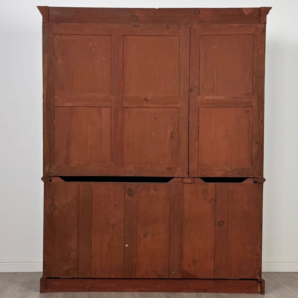 An 18th-century Georgian mahogany bookcase featuring three glazed doors with geometric astragal bars above three drawers and three panelled cupboard doors. View VI