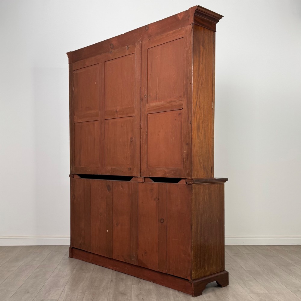 An 18th-century Georgian mahogany bookcase featuring three glazed doors with geometric astragal bars above three drawers and three panelled cupboard doors. View VII
