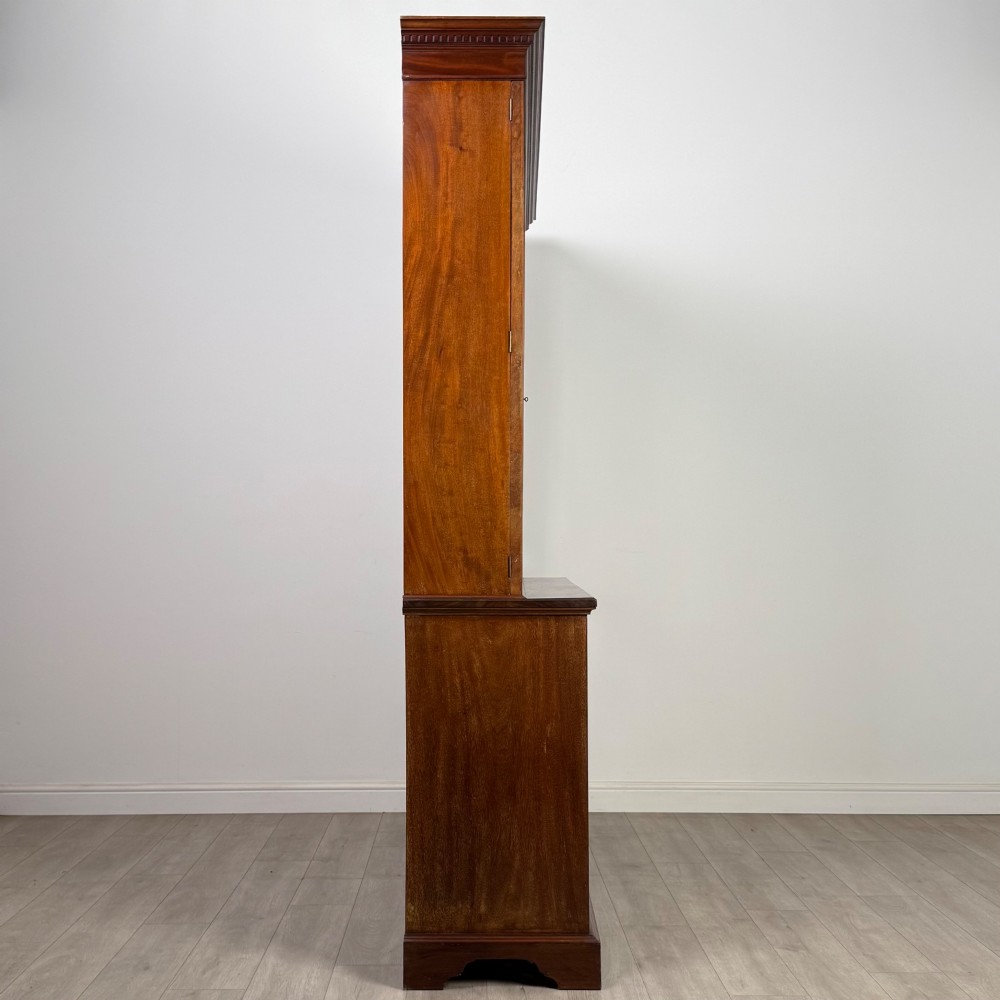 An 18th-century Georgian mahogany bookcase featuring three glazed doors with geometric astragal bars above three drawers and three panelled cupboard doors. View VIII