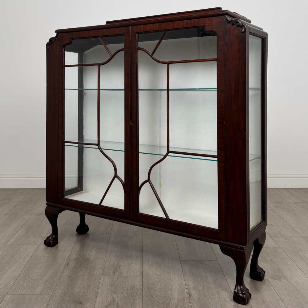 An Edwardian mahogany display cabinet featuring twin astragal glazed doors, glass interior shelves, and cabriole legs with ball and claw feet. View III