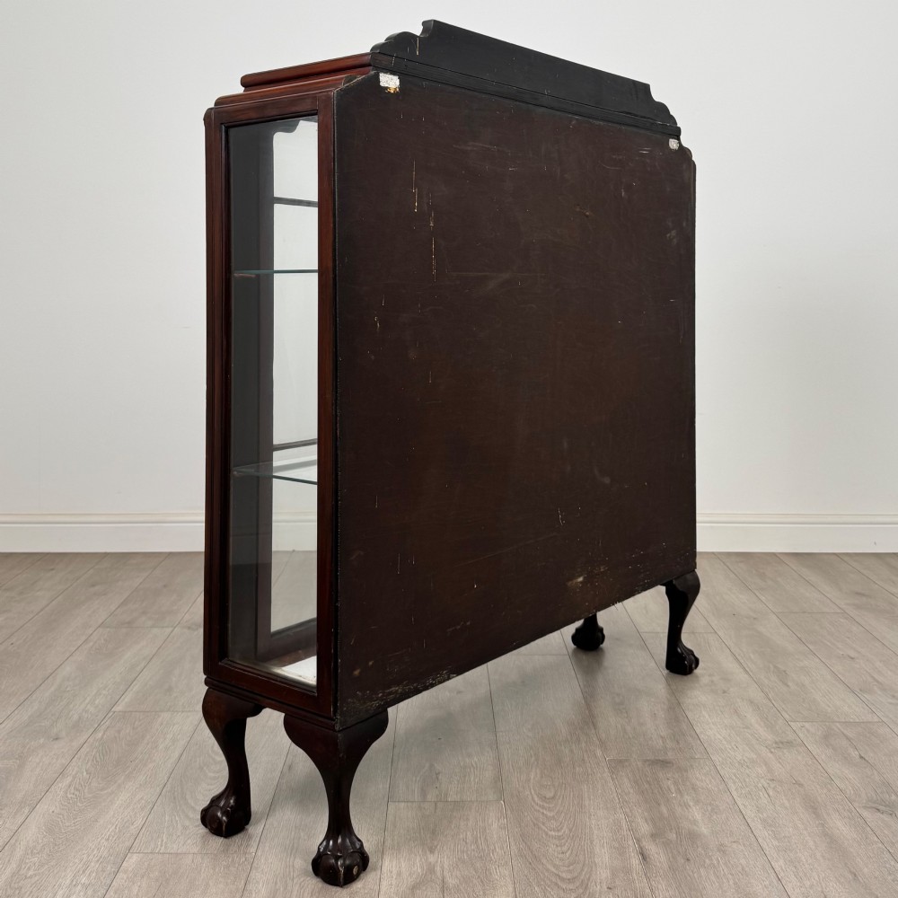 An Edwardian mahogany display cabinet featuring twin astragal glazed doors, glass interior shelves, and cabriole legs with ball and claw feet. View V