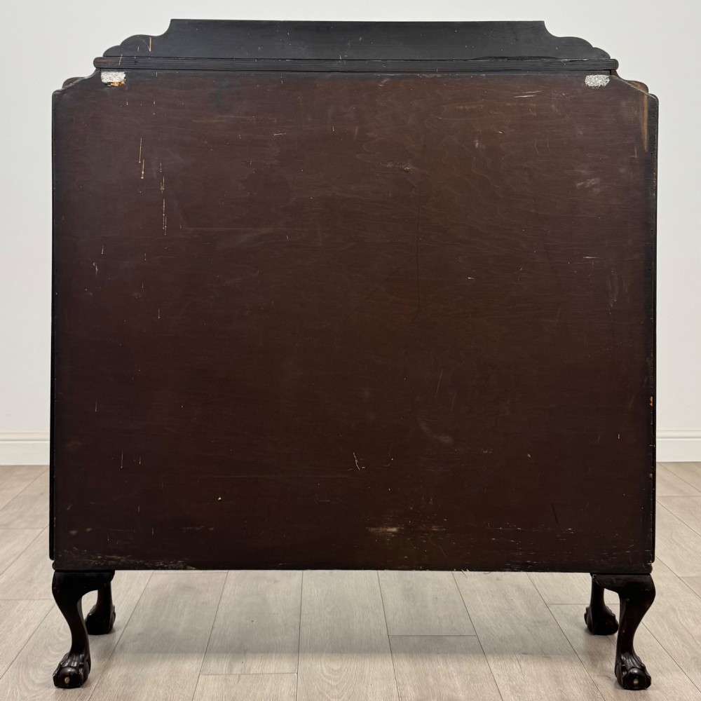 An Edwardian mahogany display cabinet featuring twin astragal glazed doors, glass interior shelves, and cabriole legs with ball and claw feet. View VI