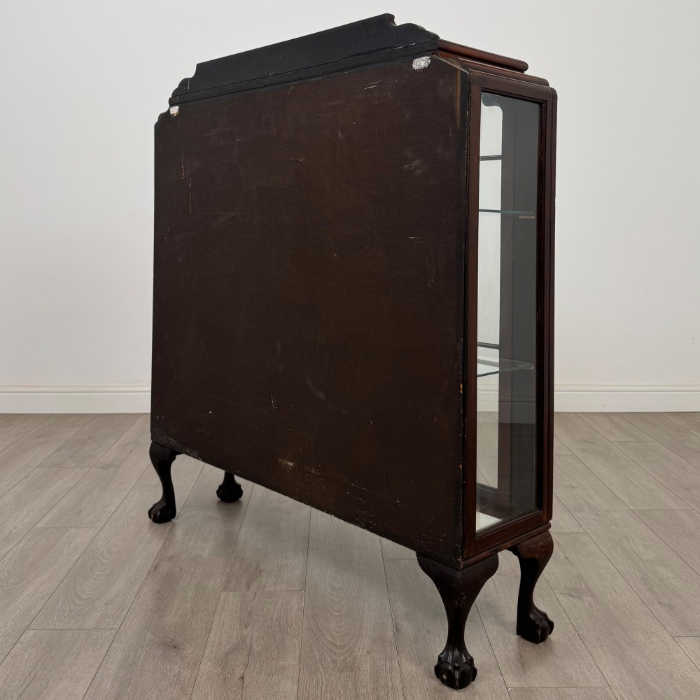 An Edwardian mahogany display cabinet featuring twin astragal glazed doors, glass interior shelves, and cabriole legs with ball and claw feet. View VII