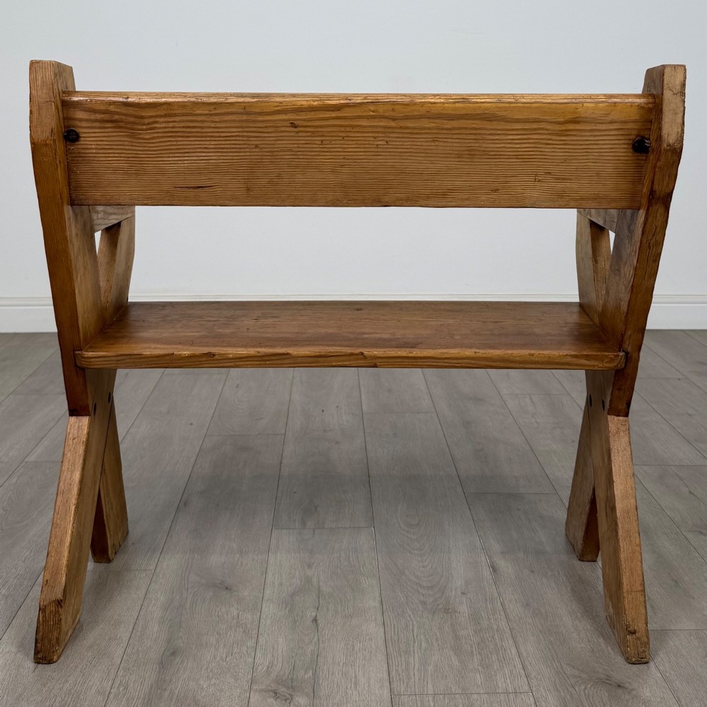 A nineteenth-century pitch pine bench featuring an X-frame structure, integrated side armrests, and a single horizontal back rail. View IV