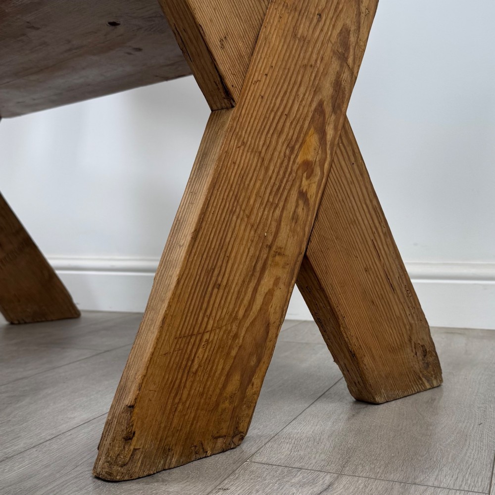 A nineteenth-century pitch pine bench featuring an X-frame structure, integrated side armrests, and a single horizontal back rail. View XI