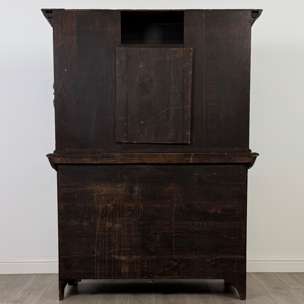 A 19th-century dark carved oak Victorian sideboard featuring an upper mirrored shelf section supported by turned bulbous pilasters above two carved drawers and cupboard doors with rosette reliefs. View VI