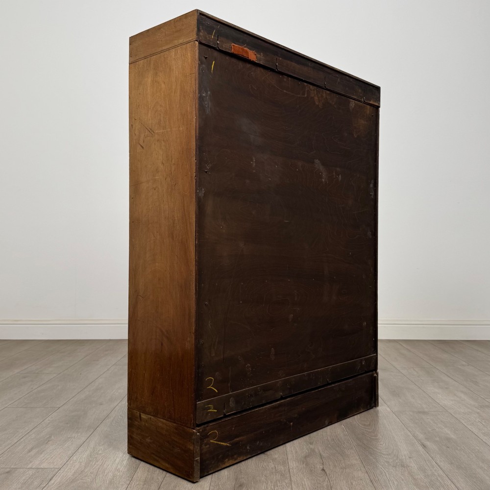 A three-tier mahogany sectional bookcase featuring lift-up glazed doors with small wooden knobs. View V