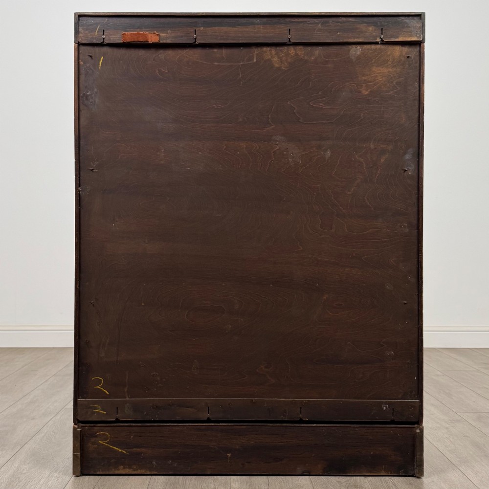 A three-tier mahogany sectional bookcase featuring lift-up glazed doors with small wooden knobs. View VI