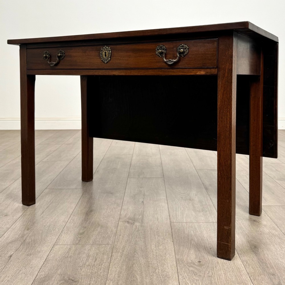 An 18th-century Georgian mahogany writing table featuring a rectangular top, a single wide frieze drawer with brass handles and central escutcheon, supported by straight square legs. View II