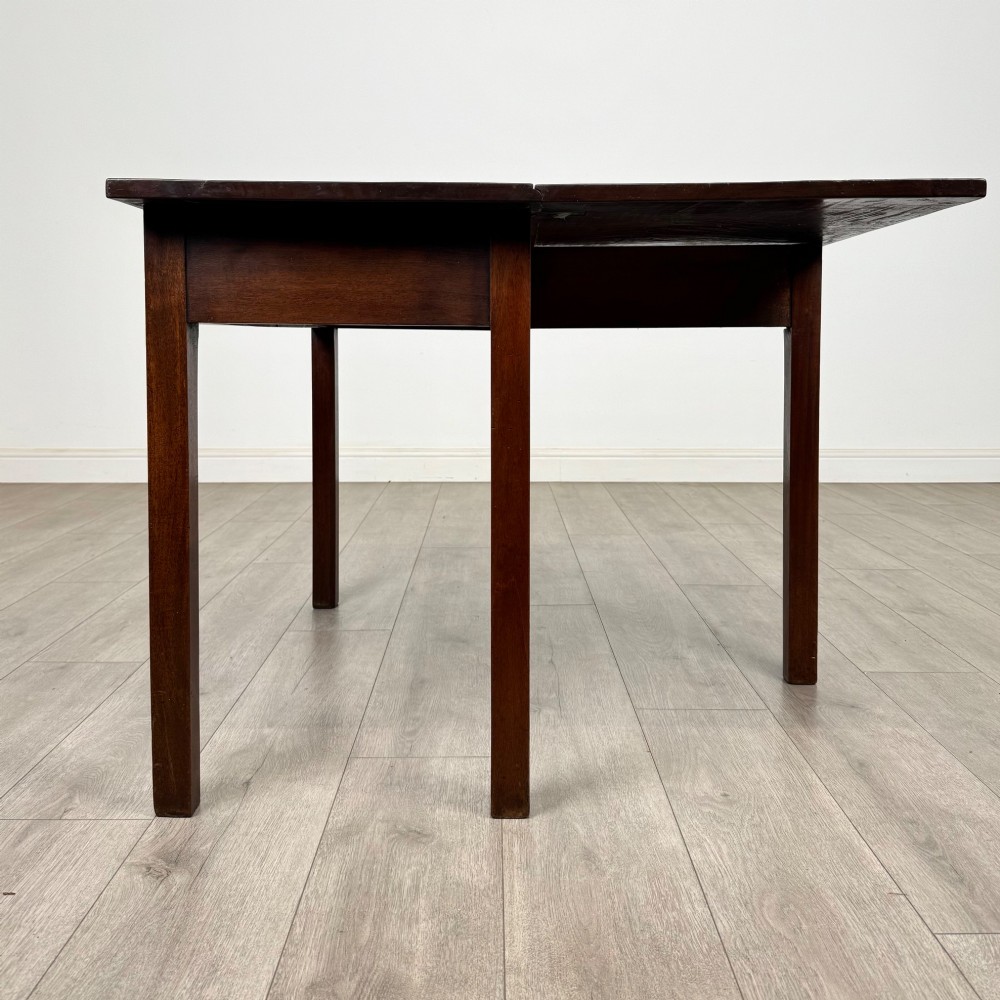 An 18th-century Georgian mahogany writing table featuring a rectangular top, a single wide frieze drawer with brass handles and central escutcheon, supported by straight square legs. View IV