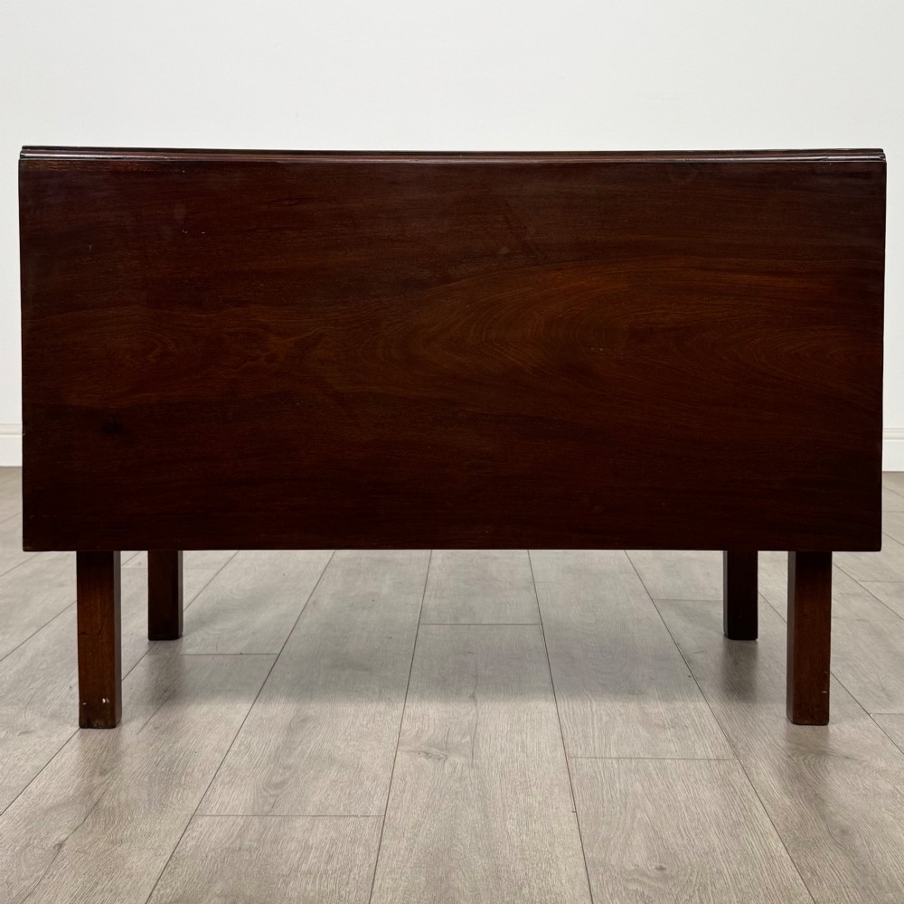 An 18th-century Georgian mahogany writing table featuring a rectangular top, a single wide frieze drawer with brass handles and central escutcheon, supported by straight square legs. View VI